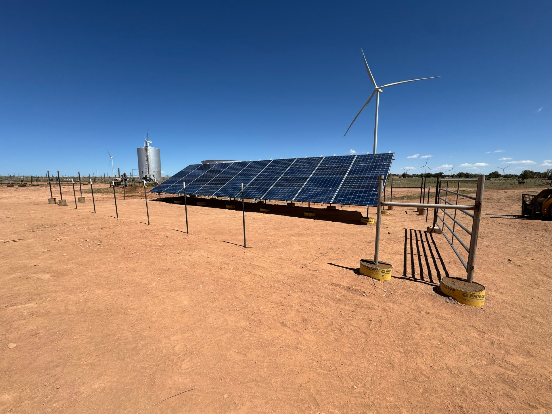 Solar direct water pumping array beside the ranch windmill