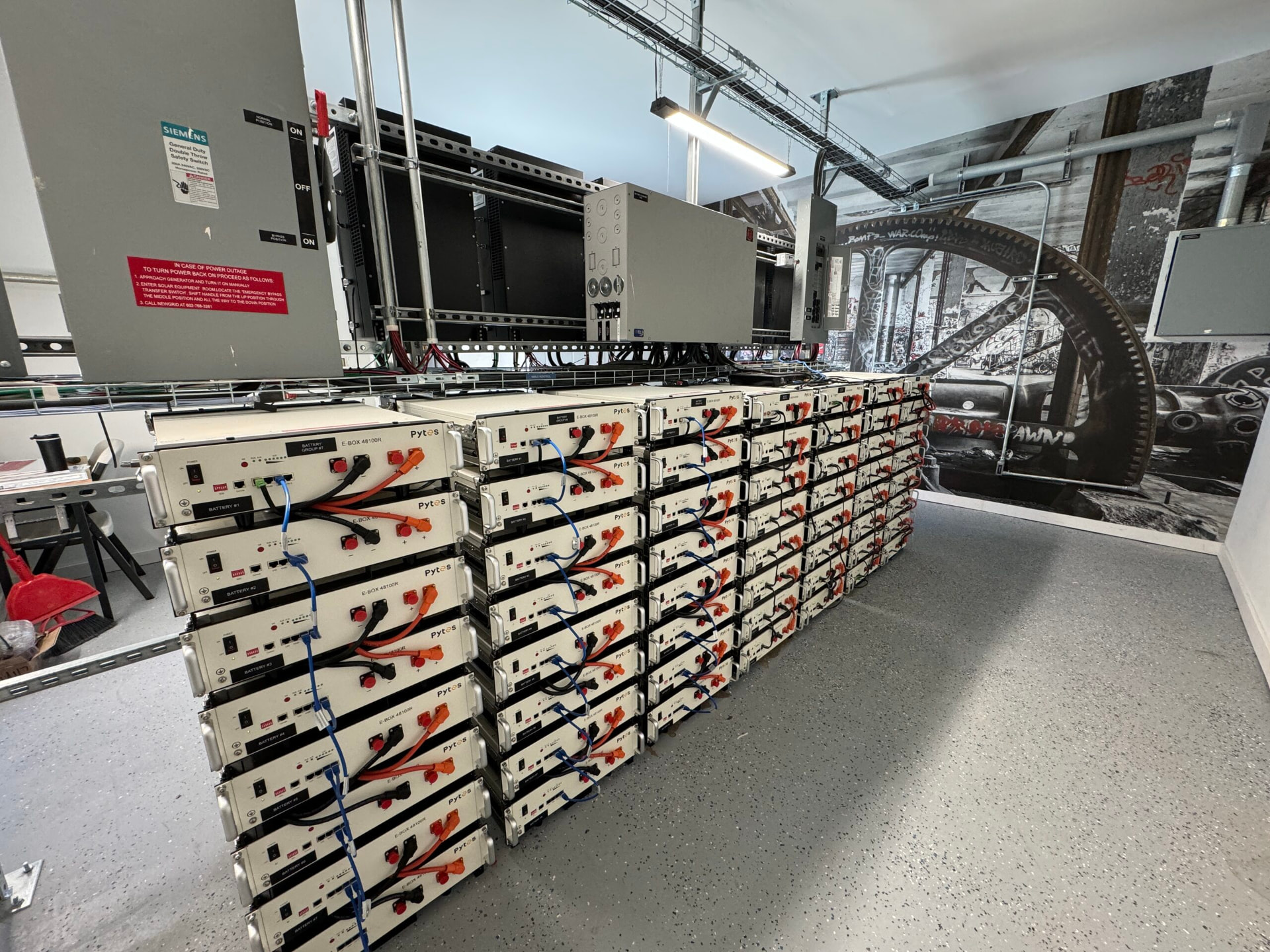 Rack-mounted lithium battery bank at the Airbnb power building