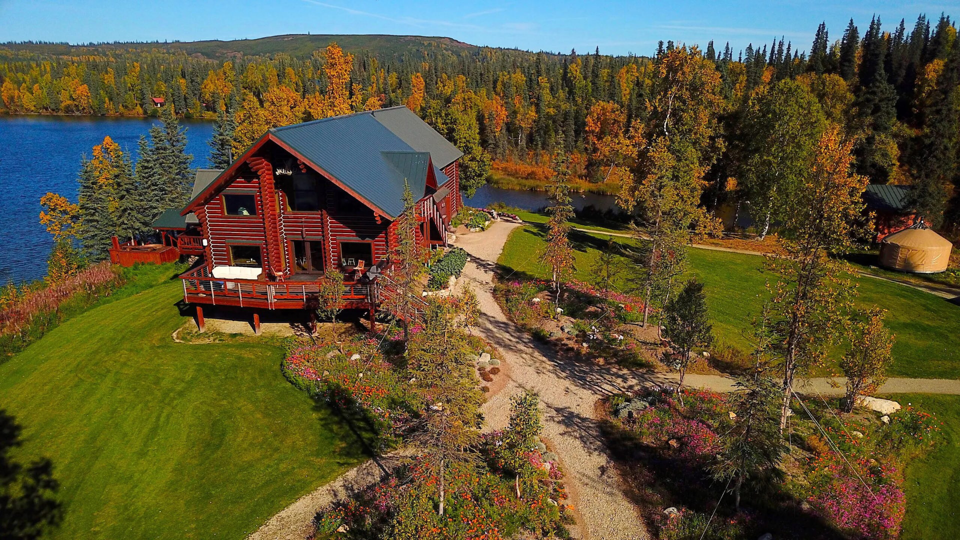 Aerial view of a remote fly-in Alaska lodge on the water, a NewGrid off-grid power site